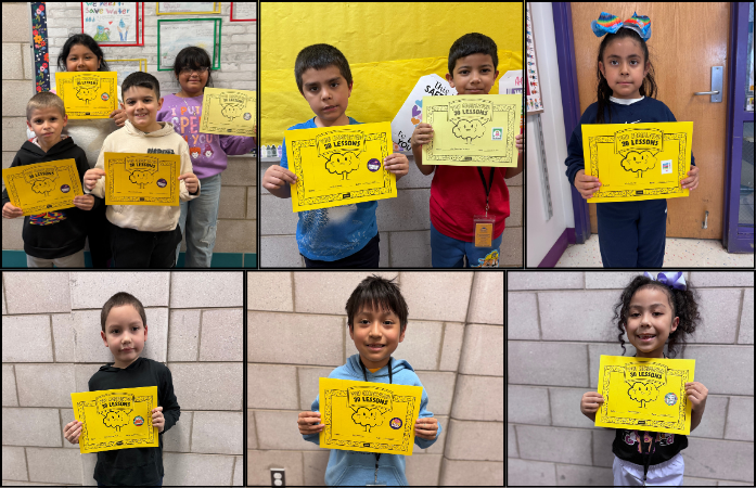 students pose in the hallway holding their certificates